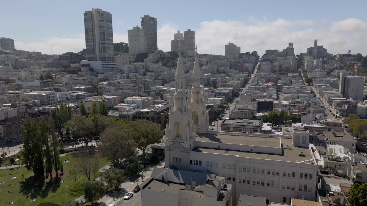 Stunning drone footage circles the historic Saints Peter and Paul Church in San Francisco's Little Italy, offering glimpses of Washington Square, the Transamerica Pyramid, and the downtown skyline.