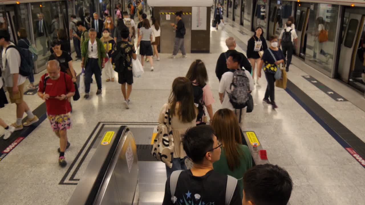 Busy Crowd on Escalator in Hong Kong Subway Station