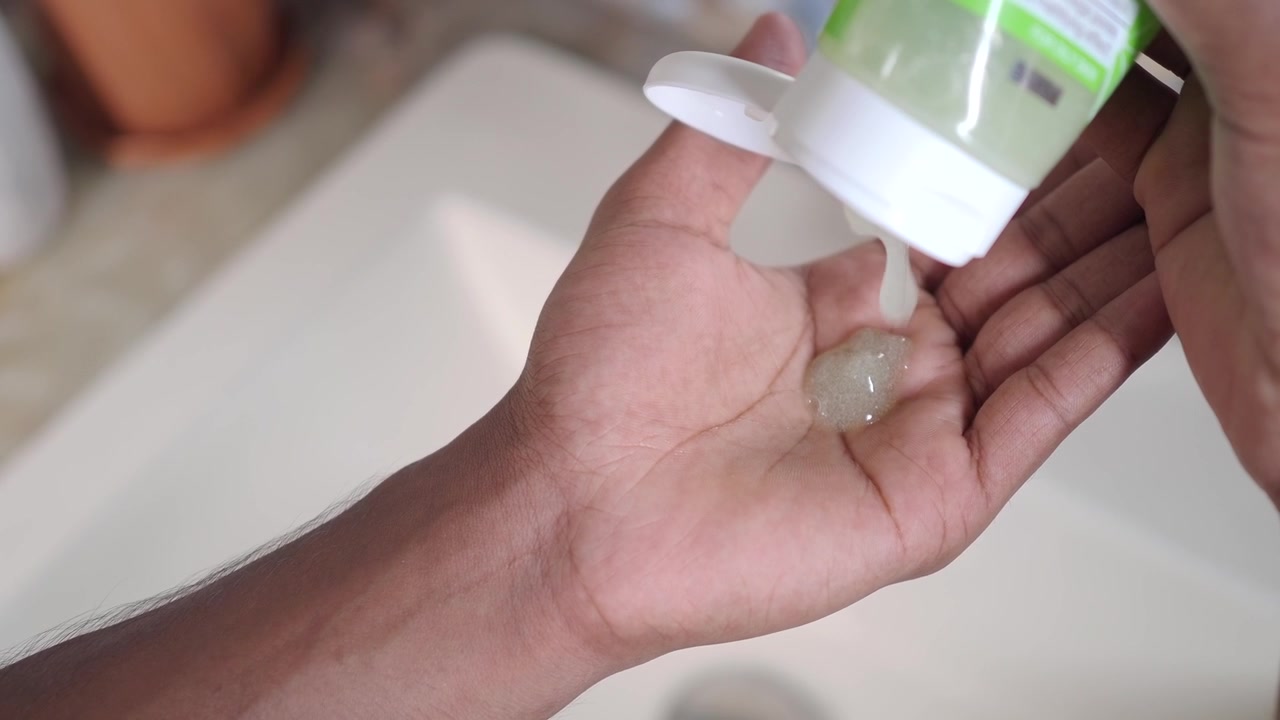 Person Squeezing Gel Cleanser onto Palm