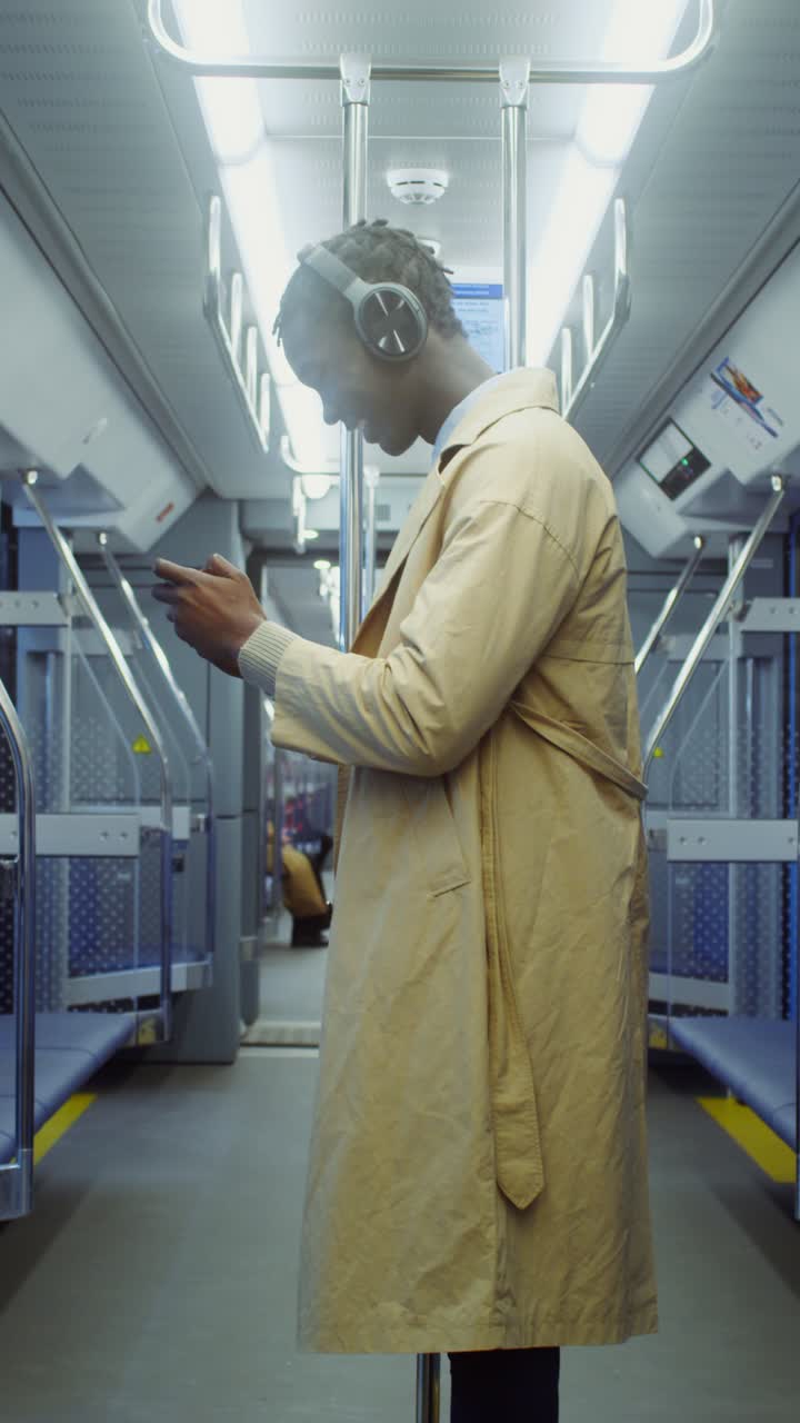 Man with headphones on a subway train