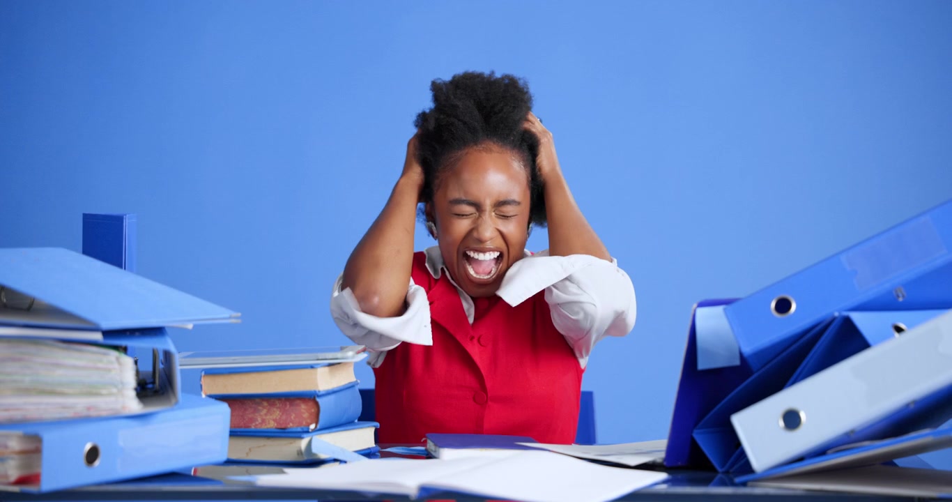 Stressed Office Worker Screaming at Desk with Paperwork