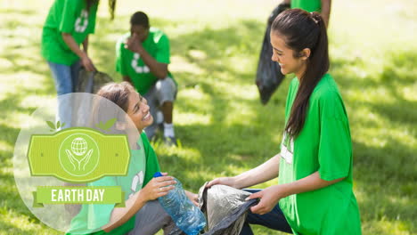 animation of earth day text and logo over smiling women doing cleaning work in forest