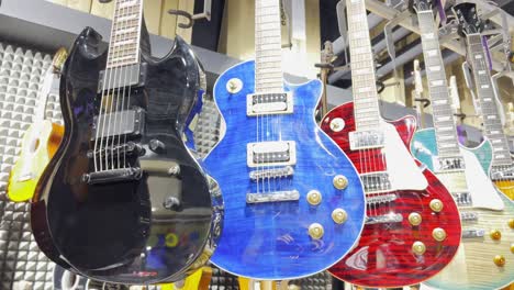 a store of electric guitars of various colors. concept of musical instruments.
