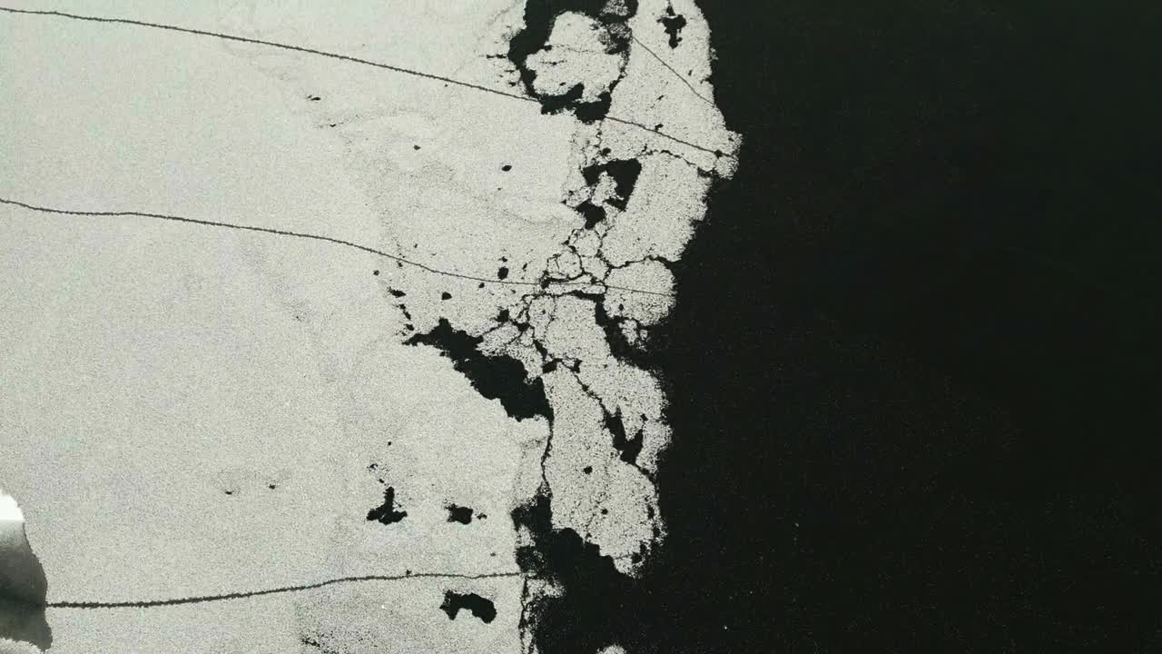 Partially frozen lake with ice from a bird's eye view