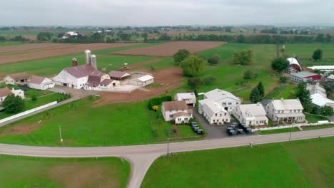 drone ariel view of amish farm lands and amish sunday meeting