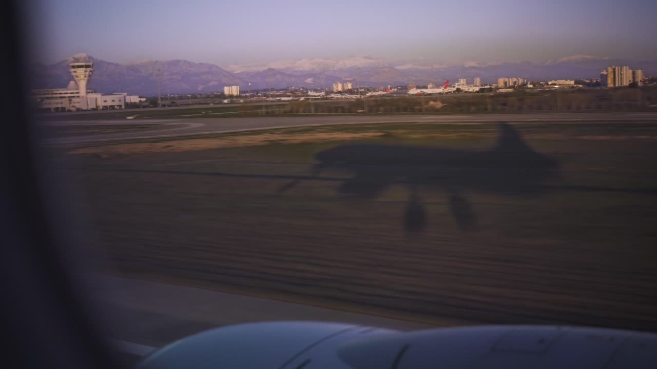 window view of huge airplane landing moment; airplane shadow landing