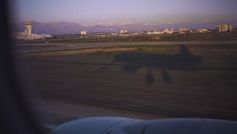 window view of huge airplane landing moment; airplane shadow landing