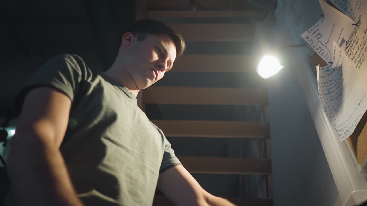 Person adjusting digital panel controls in a professional workspace, interacting with equipment and screen, focused on making adjustments to sliders and buttons, working on technical tasks