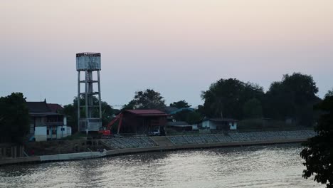 boat moves across river during a serene sunset