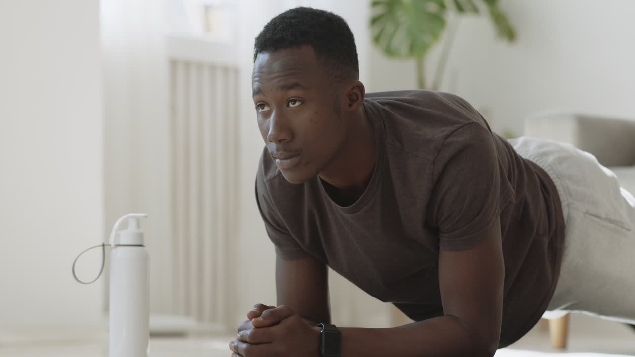 Man doing plank exercise at home