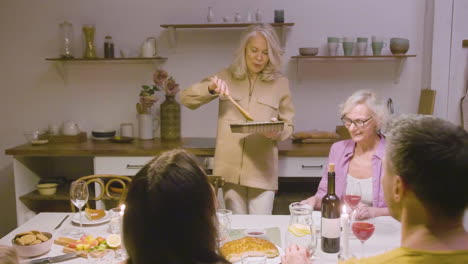 family sitting at the table during dinner at home