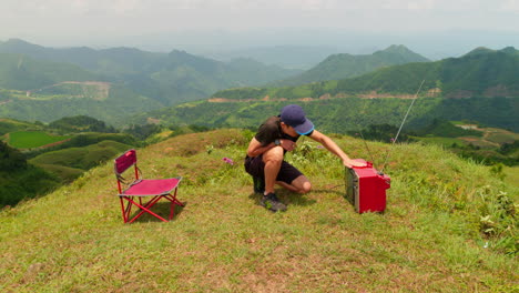 Quirky-video-of-male-adjusting-old-TV-reception-by-banging-in-outdoor-nature