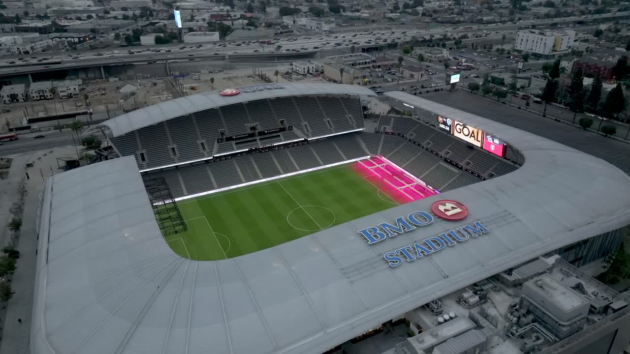 Rising Aerial Shot Of BMO Soccer Stadium with Cars Driving On 110 Freeway In Los Angeles, California