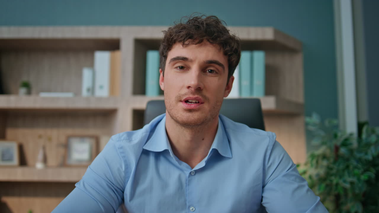 Pov entrepreneur talking camera interview in office. Online coach waving hand