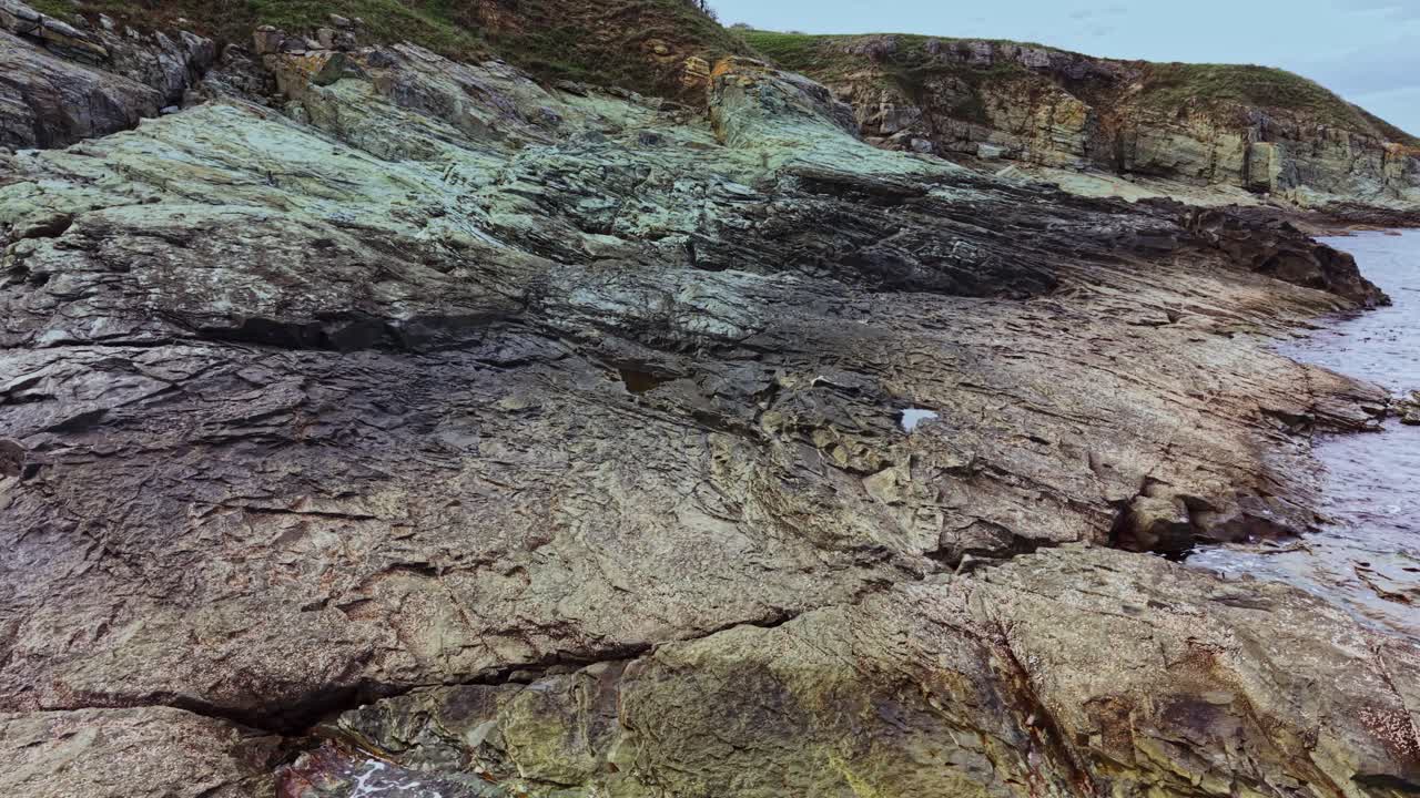 Rocky coastal landscape viewed from above during calm weather