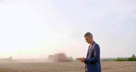 agriculture farmer using digital tablet during harvesting 4