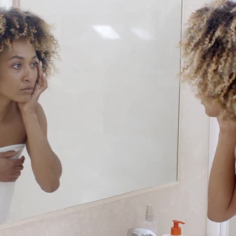 happy young woman looking on mirror