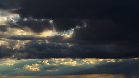 dramatic sunset sky time lapse, bright sunlight and dark silhouette of clouds as a background, extreme weather