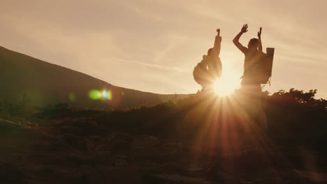 Success-On-Top-And-Leadership-A-Pair-Of-Mountaineers-With-Backpacks-Behind-Their-Back-Hitting-Each-O