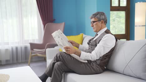 the old man is reading the newspaper.
