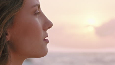 close up portrait of beautiful woman enjoying calm seaside at sunset exploring spirituality looking up praying contemplating journey relaxing on beach