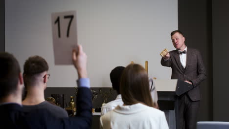 people in an antiques auction session