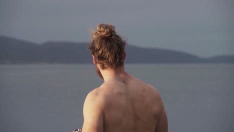 portrait of a european man removing sweatshirt outdoor