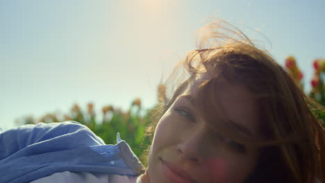 pretty girl feeling happy in sunlight. confident woman playing with blond hair.