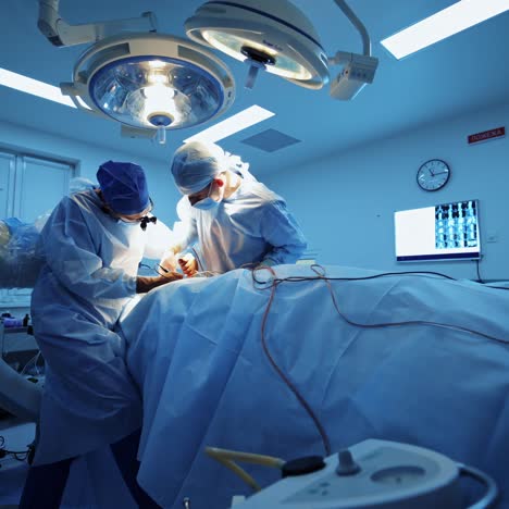 operation room with specialists. teamwork of surgeons performing operation on the background of modern equipment in private clinic