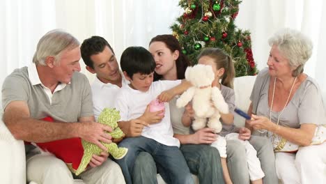 family playing with christmas gifts in the livingroom