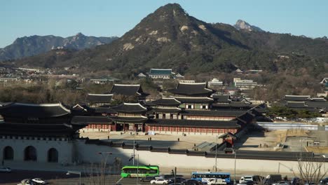 Panoramic-view-of-Gwanghwamun-Gyeongbokgung-Palace-with-a-mountain-Bugaksan-in-Seoul-Korea,-top-view,-wintertime