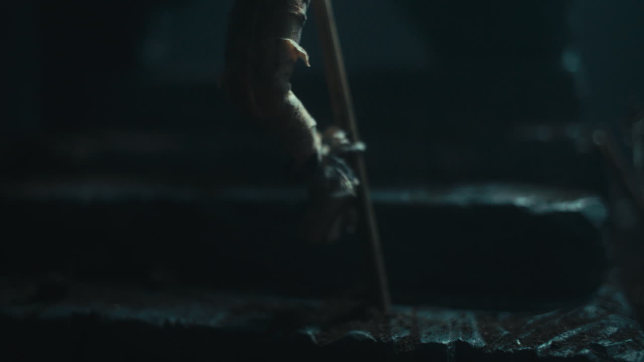 A miniature mummified dolls hanging on the gallows at night