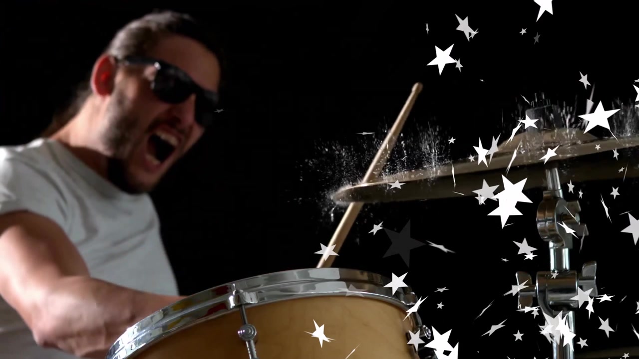 Drummer raising arm and shouting initiating cymbal strike releasing star confetti for music promo