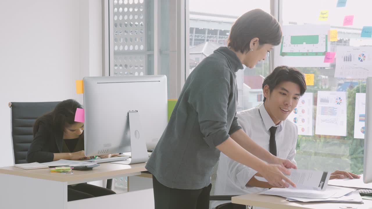 Young asian businessman gets paper with good news from executive, appreciating for good job, employee recognition