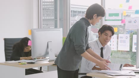 young asian businessman gets paper with good news from executive, appreciating for good job, employee recognition