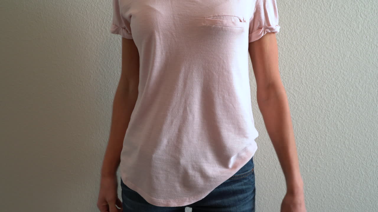 donna che tira su la camicia per afferrare la pistola nascosta nella sua vita