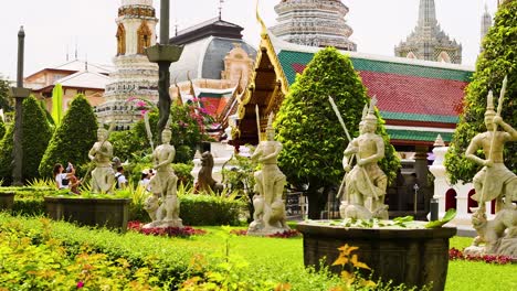 statues in temple garden with lush greenery