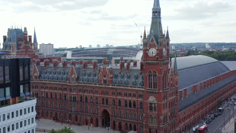 Descending-aerial-footage-of-majestic-red-brick-historic-building-of-St-Pancras-train-station-and-hotel.-London,-UK