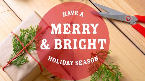 animation of have a merry and bright christmas text over christmas decorations on wooden background