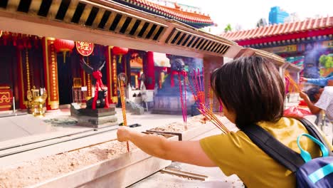 people offering incense at a hong kong temple