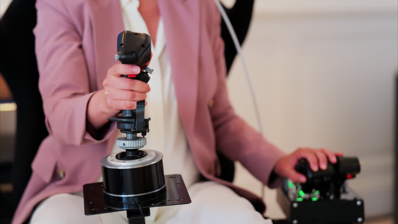 Close up of a woman's hand playing Virtual Reality games, holding a handle