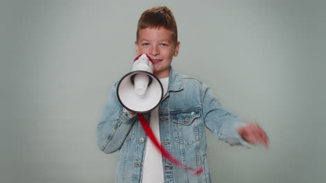 smiling toddler boy talking with megaphone, proclaiming news, loudly announcing sale advertisement