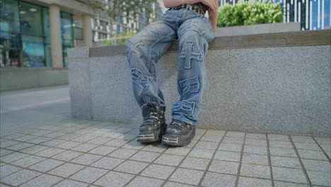 Outdoor-Fashion-Portrait-Of-Young-Alternative-Style-Woman-With-Tattoos-And-Piercing-Sitting-Outside-Modern-Buildings-Shot-In-Real-Time-1