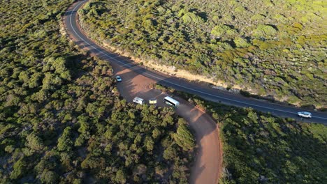 Tourist-bus-driving-on-coastal-road-of-Gracetown-beach-in-Margaret-River-region-of-Western-Australia-at-sunset