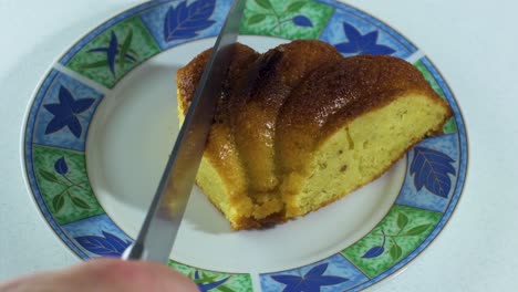 knife cuts a piece of homemade cake