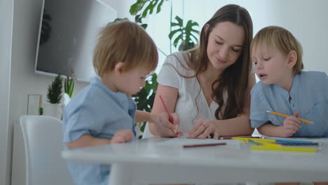 mamá elogia a dos hijos por sus dibujos. apoyo familiar y cuidado de los niños, maternidad