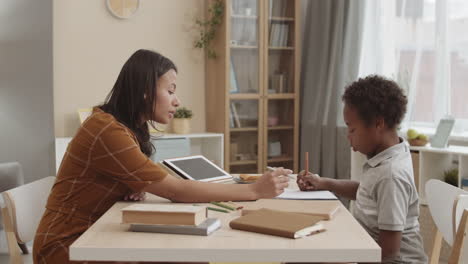 mother and son doing homework at home