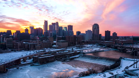 aerial hyperlapse of the sun setting behind minneapolis skyscrapers with st anthony falls in the foreground