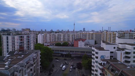 Fantastic-aerial-top-view-flight-City-Berlin-suburban-railroad-station-prefabricated-building-skyscrapers-district-Neukoeln,-Germany-Summer-day-2023