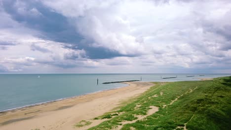 Aerial-shot-flying-and-panning-over-a-sand-beach-on-the-English-coast